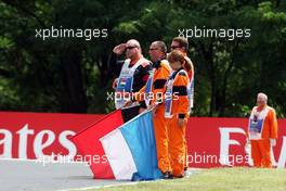 Marshals observe the pre-race tribute to Jules Bianchi. 26.07.2015. Formula 1 World Championship, Rd 10, Hungarian Grand Prix, Budapest, Hungary, Race Day.