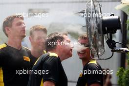 Pirelli tyre technicians cool themselves with misted fans in the paddock. 23.07.2015. Formula 1 World Championship, Rd 10, Hungarian Grand Prix, Budapest, Hungary, Preparation Day.