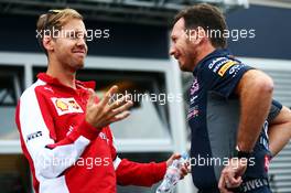 (L to R): Sebastian Vettel (GER) Ferrari with Christian Horner (GBR) Red Bull Racing Team Principal. 04.09.2015. Formula 1 World Championship, Rd 12, Italian Grand Prix, Monza, Italy, Practice Day.