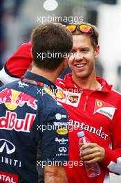 (L to R): Christian Horner (GBR) Red Bull Racing Team Principal with Sebastian Vettel (GER) Ferrari. 04.09.2015. Formula 1 World Championship, Rd 12, Italian Grand Prix, Monza, Italy, Practice Day.