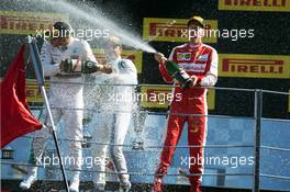 (L to R): Race winner Lewis Hamilton (GBR) Mercedes AMG F1 and second placed Sebastian Vettel (GER) Ferrari celebrate on the podium. 06.09.2015. Formula 1 World Championship, Rd 12, Italian Grand Prix, Monza, Italy, Race Day.