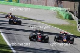 Jenson Button (GBR) McLaren MP4-30 and Carlos Sainz Jr (ESP) Scuderia Toro Rosso STR10 battle for position. 06.09.2015. Formula 1 World Championship, Rd 12, Italian Grand Prix, Monza, Italy, Race Day.
