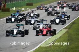 (L to R): Lewis Hamilton (GBR) Mercedes AMG F1 W06 and Sebastian Vettel (GER) Ferrari SF15-T at the start of the race. 06.09.2015. Formula 1 World Championship, Rd 12, Italian Grand Prix, Monza, Italy, Race Day.