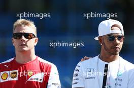 (L to R): Kimi Raikkonen (FIN) Ferrari and Lewis Hamilton (GBR) Mercedes AMG F1 on the drivers parade observe a minute's silence for Justin Wilson. 06.09.2015. Formula 1 World Championship, Rd 12, Italian Grand Prix, Monza, Italy, Race Day.