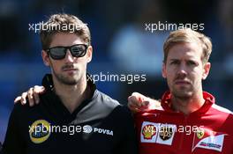 (L to R): Romain Grosjean (FRA) Lotus F1 Team and Sebastian Vettel (GER) Ferrari on the drivers parade observe a minute's silence for Justin Wilson. 06.09.2015. Formula 1 World Championship, Rd 12, Italian Grand Prix, Monza, Italy, Race Day.