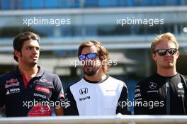 (L to R): Carlos Sainz Jr (ESP) Scuderia Toro Rosso; Fernando Alonso (ESP) McLaren; and Nico Rosberg (GER) Mercedes AMG F1 on the drivers parade observe a minute's silence for Justin Wilson. 06.09.2015. Formula 1 World Championship, Rd 12, Italian Grand Prix, Monza, Italy, Race Day.