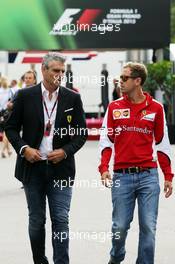 (L to R): Maurizio Arrivabene (ITA) Ferrari Team Principal with Sebastian Vettel (GER) Ferrari. 03.09.2015. Formula 1 World Championship, Rd 12, Italian Grand Prix, Monza, Italy, Preparation Day.