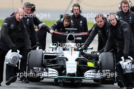 Lewis Hamilton (GBR) Mercedes AMG F1 W06 is pushed down the pit lane by mechanics after he stopped. 02.02.2015. Formula One Testing, Day Two, Jerez, Spain.