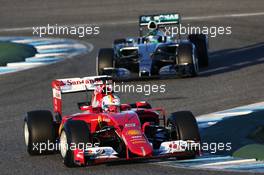 Sebastian Vettel (GER) Ferrari SF15-T leads Nico Rosberg (GER) Mercedes AMG F1 W06. 01.02.2015. Formula One Testing, Day One, Jerez, Spain.