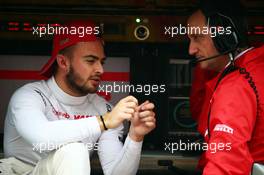 (L to R): Will Stevens (GBR) Manor Marussia F1 Team with Gianluca Pisanello (ITA) Manor Marussia F1 Team Chief Engineer on the pit gantry. 25.09.2015. Formula 1 World Championship, Rd 14, Japanese Grand Prix, Suzuka, Japan, Practice Day.