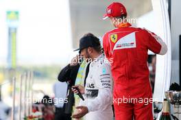 (L to R): Race winner Lewis Hamilton (GBR) Mercedes AMG F1 celebrates on the podium with third placed Sebastian Vettel (GER) Ferrari. 27.09.2015. Formula 1 World Championship, Rd 14, Japanese Grand Prix, Suzuka, Japan, Race Day.