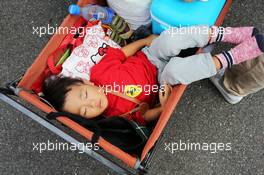 A young fan sleeps in a trolley. 26.09.2015. Formula 1 World Championship, Rd 14, Japanese Grand Prix, Suzuka, Japan, Qualifying Day.