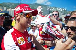 Sebastian Vettel (GER) Ferrari signs autographs for the fans. 22.05.2015. Formula 1 World Championship, Rd 6, Monaco Grand Prix, Monte Carlo, Monaco, Friday.