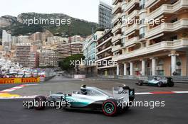 Nico Rosberg (GER) Mercedes AMG F1 W06 as team mate Lewis Hamilton (GBR) Mercedes AMG F1 W06 runs wide. 23.05.2015. Formula 1 World Championship, Rd 6, Monaco Grand Prix, Monte Carlo, Monaco, Qualifying Day
