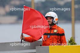 Marshal waves a red flag as the session is stopped. 21.05.2015. Formula 1 World Championship, Rd 6, Monaco Grand Prix, Monte Carlo, Monaco, Practice Day.