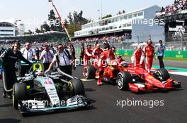 (L to R): Lewis Hamilton (GBR) Mercedes AMG F1 W06 and Kimi Raikkonen (FIN) Ferrari SF15-T on the grid. 01.11.2015. Formula 1 World Championship, Rd 17, Mexican Grand Prix, Mexixo City, Mexico, Race Day.