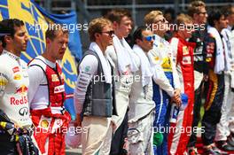 Sebastian Vettel (GER) Ferrari as the grid observes the national anthem. 29.03.2015. Formula 1 World Championship, Rd 2, Malaysian Grand Prix, Sepang, Malaysia, Sunday.
