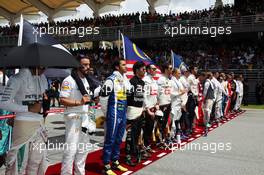 The grid observes the national anthem. 29.03.2015. Formula 1 World Championship, Rd 2, Malaysian Grand Prix, Sepang, Malaysia, Sunday.