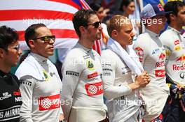 Pastor Maldonado (VEN) Lotus F1 Team and Romain Grosjean (FRA) Lotus F1 Team as the grid observes the national anthem. 29.03.2015. Formula 1 World Championship, Rd 2, Malaysian Grand Prix, Sepang, Malaysia, Sunday.