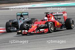Sebastian Vettel (GER), Scuderia Ferrari and Nico Rosberg (GER), Mercedes AMG F1 Team  29.03.2015. Formula 1 World Championship, Rd 2, Malaysian Grand Prix, Sepang, Malaysia, Sunday.