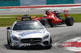 Sebastian Vettel (GER) Ferrari SF15-T leads behind the FIA Safety Car. 29.03.2015. Formula 1 World Championship, Rd 2, Malaysian Grand Prix, Sepang, Malaysia, Sunday.