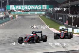 Fernando Alonso (ESP), McLaren Honda and Jenson Button (GBR), McLaren Honda  29.03.2015. Formula 1 World Championship, Rd 2, Malaysian Grand Prix, Sepang, Malaysia, Sunday.