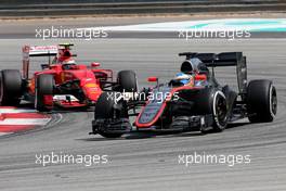 Fernando Alonso (ESP), McLaren Honda and Kimi Raikkonen (FIN), Scuderia Ferrari  29.03.2015. Formula 1 World Championship, Rd 2, Malaysian Grand Prix, Sepang, Malaysia, Sunday.