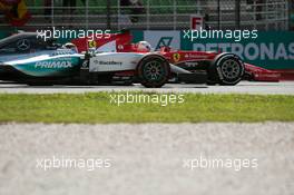 Lewis Hamilton (GBR) Mercedes AMG F1 W06 and Sebastian Vettel (GER) Ferrari SF15-T battle for the lead of the race. 29.03.2015. Formula 1 World Championship, Rd 2, Malaysian Grand Prix, Sepang, Malaysia, Sunday.