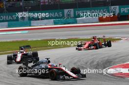 Fernando Alonso (ESP) McLaren MP4-30 leads team mate Jenson Button (GBR) McLaren MP4-30 and Kimi Raikkonen (FIN) Ferrari SF15-T, who has a puncture. 29.03.2015. Formula 1 World Championship, Rd 2, Malaysian Grand Prix, Sepang, Malaysia, Sunday.
