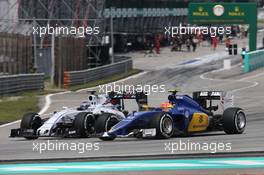 (L to R): Valtteri Bottas (FIN) Williams FW37 and Felipe Nasr (BRA) Sauber C34 battle for position. 29.03.2015. Formula 1 World Championship, Rd 2, Malaysian Grand Prix, Sepang, Malaysia, Sunday.