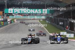 (L to R): Nico Hulkenberg (GER) Sahara Force India F1 VJM08 and Marcus Ericsson (SWE) Sauber C34 battle for position. 29.03.2015. Formula 1 World Championship, Rd 2, Malaysian Grand Prix, Sepang, Malaysia, Sunday.