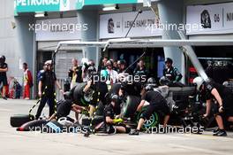 Lewis Hamilton (GBR) Mercedes AMG F1 W06 makes a pit stop during qualifying. 28.03.2015. Formula 1 World Championship, Rd 2, Malaysian Grand Prix, Sepang, Malaysia, Saturday.