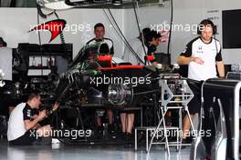The McLaren MP4-30 is prepared in the pit garage. 26.03.2015. Formula 1 World Championship, Rd 2, Malaysian Grand Prix, Sepang, Malaysia, Thursday.