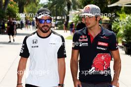 (L to R): Fernando Alonso (ESP) McLaren with Carlos Sainz Jr (ESP) Scuderia Toro Rosso. 26.03.2015. Formula 1 World Championship, Rd 2, Malaysian Grand Prix, Sepang, Malaysia, Thursday.