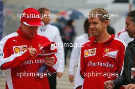 (L to R): Kimi Raikkonen (FIN) Ferrari with team mate Sebastian Vettel (GER) Ferrari. 09.10.2015. Formula 1 World Championship, Rd 15, Russian Grand Prix, Sochi Autodrom, Sochi, Russia, Practice Day.