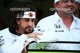 (L to R): Fernando Alonso (ESP) McLaren celebrates his 250th GP with Eric Boullier (FRA) McLaren Racing Director. 09.10.2015. Formula 1 World Championship, Rd 15, Russian Grand Prix, Sochi Autodrom, Sochi, Russia, Practice Day.