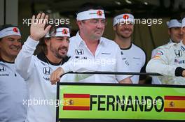 (L to R): Fernando Alonso (ESP) McLaren celebrates his 250th GP with Eric Boullier (FRA) McLaren Racing Director and the team. 09.10.2015. Formula 1 World Championship, Rd 15, Russian Grand Prix, Sochi Autodrom, Sochi, Russia, Practice Day.