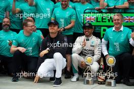 Race winner Lewis Hamilton (GBR) Mercedes AMG F1 celebrates with team mate Nico Rosberg (GER) Mercedes AMG F1 and the team. 11.10.2015. Formula 1 World Championship, Rd 15, Russian Grand Prix, Sochi Autodrom, Sochi, Russia, Race Day.