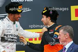 (L to R): Race winner Lewis Hamilton (GBR) Mercedes AMG F1 celebrates on the podium with third placed Sergio Perez (MEX) Sahara Force India F1. 11.10.2015. Formula 1 World Championship, Rd 15, Russian Grand Prix, Sochi Autodrom, Sochi, Russia, Race Day.