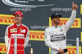 (L to R): second placed Sebastian Vettel (GER) Ferrari with race winner Lewis Hamilton (GBR) Mercedes AMG F1 on the podium. 11.10.2015. Formula 1 World Championship, Rd 15, Russian Grand Prix, Sochi Autodrom, Sochi, Russia, Race Day.