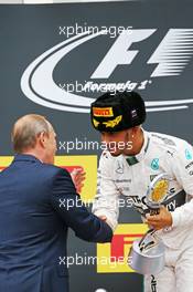 Race winner Lewis Hamilton (GBR) Mercedes AMG F1 celebrates on the podium with Vladimir Putin (RUS) Russian Federation President. 11.10.2015. Formula 1 World Championship, Rd 15, Russian Grand Prix, Sochi Autodrom, Sochi, Russia, Race Day.