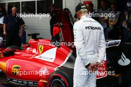 Lewis Hamilton (GBR) Mercedes AMG F1 looks at the Ferrari SF15-T of Sebastian Vettel (GER) Ferrari in parc ferme. 10.10.2015. Formula 1 World Championship, Rd 15, Russian Grand Prix, Sochi Autodrom, Sochi, Russia, Qualifying Day.