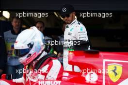 Lewis Hamilton (GBR) Mercedes AMG F1 W06 looks at the Ferrari SF15-T of Sebastian Vettel (GER) Ferrari in parc ferme. 10.10.2015. Formula 1 World Championship, Rd 15, Russian Grand Prix, Sochi Autodrom, Sochi, Russia, Qualifying Day.