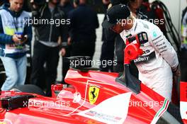 Lewis Hamilton (GBR) Mercedes AMG F1 looks at the Ferrari SF15-T of Sebastian Vettel (GER) Ferrari in parc ferme. 10.10.2015. Formula 1 World Championship, Rd 15, Russian Grand Prix, Sochi Autodrom, Sochi, Russia, Qualifying Day.