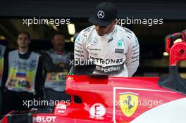 Lewis Hamilton (GBR) Mercedes AMG F1 W06 looks at the Ferrari SF15-T of Sebastian Vettel (GER) Ferrari in parc ferme. 10.10.2015. Formula 1 World Championship, Rd 15, Russian Grand Prix, Sochi Autodrom, Sochi, Russia, Qualifying Day.