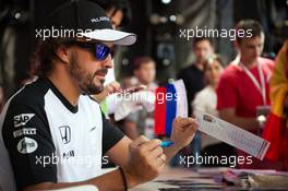 Fernando Alonso (ESP) McLaren signs autographs for the fans. 08.10.2015. Formula 1 World Championship, Rd 15, Russian Grand Prix, Sochi Autodrom, Sochi, Russia, Preparation Day.