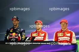 The post race FIA Press Conference (L to R): Daniel Ricciardo (AUS) Red Bull Racing, second; Sebastian Vettel (GER) Ferrari, race winner; Kimi Raikkonen (FIN) Ferrari, third. 20.09.2015. Formula 1 World Championship, Rd 13, Singapore Grand Prix, Singapore, Singapore, Race Day.
