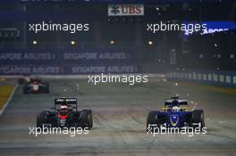 (L to R): Jenson Button (GBR) McLaren MP4-30 and Marcus Ericsson (SWE) Sauber C34 battle for position. 20.09.2015. Formula 1 World Championship, Rd 13, Singapore Grand Prix, Singapore, Singapore, Race Day.