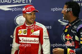 (L to R): Pole sitter Sebastian Vettel (GER) Ferrari with second placed Daniel Ricciardo (AUS) Red Bull Racing. 19.09.2015. Formula 1 World Championship, Rd 13, Singapore Grand Prix, Singapore, Singapore, Qualifying Day.