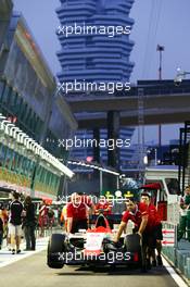The Manor Marussia F1 Team car of Alexander Rossi (USA) Manor Marussia F1 Team is pushed by mechanics to scrutineering. 17.09.2015. Formula 1 World Championship, Rd 13, Singapore Grand Prix, Singapore, Singapore, Preparation Day.